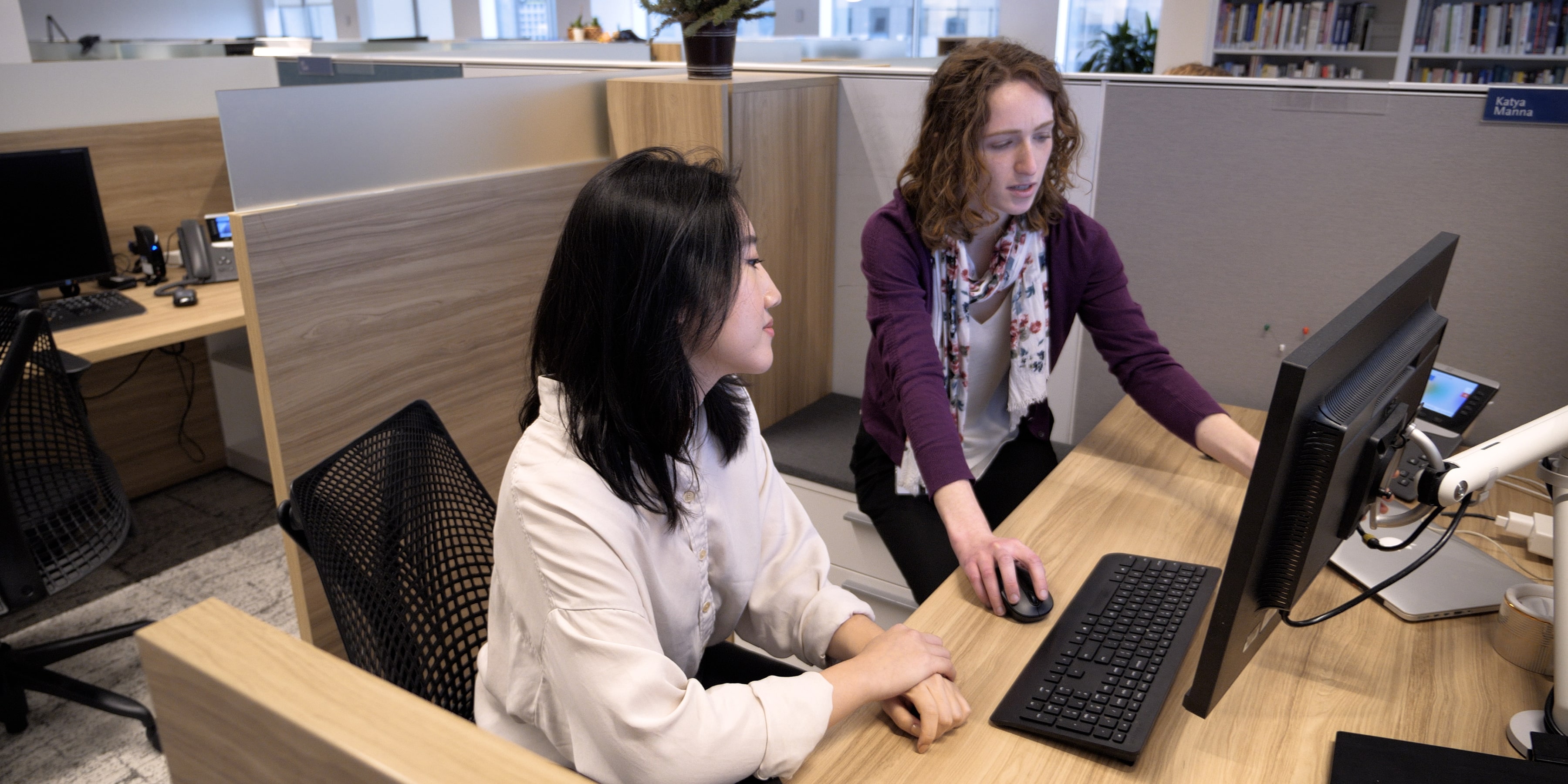 Two female MDRC employees consult about a project