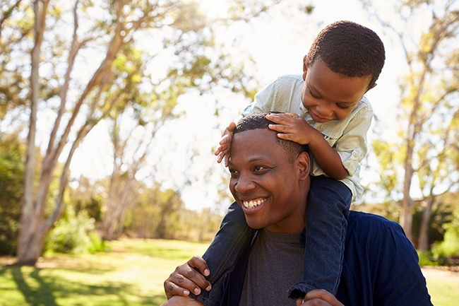 Dad giving young son a piggyback ride
