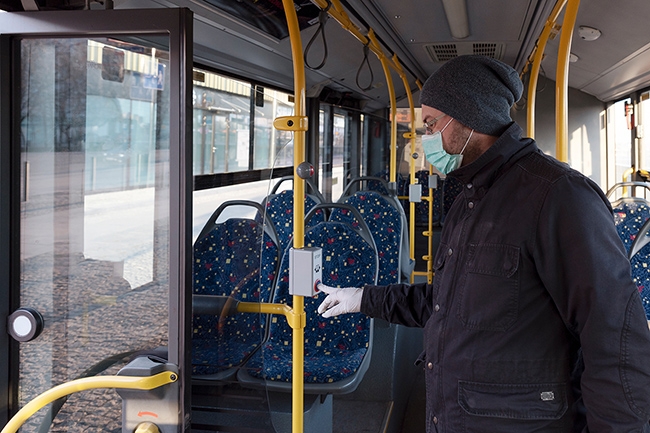 Man in face mask on city bus
