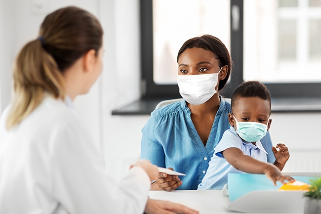 African American mom and toddler son in doctor's office