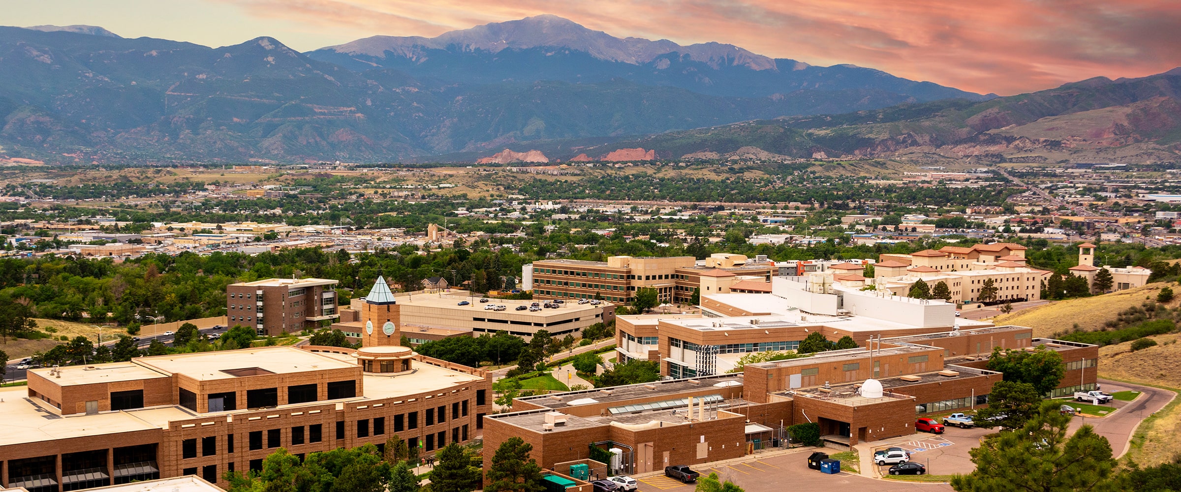Midwestern university campus shown from above, with mountains in the background