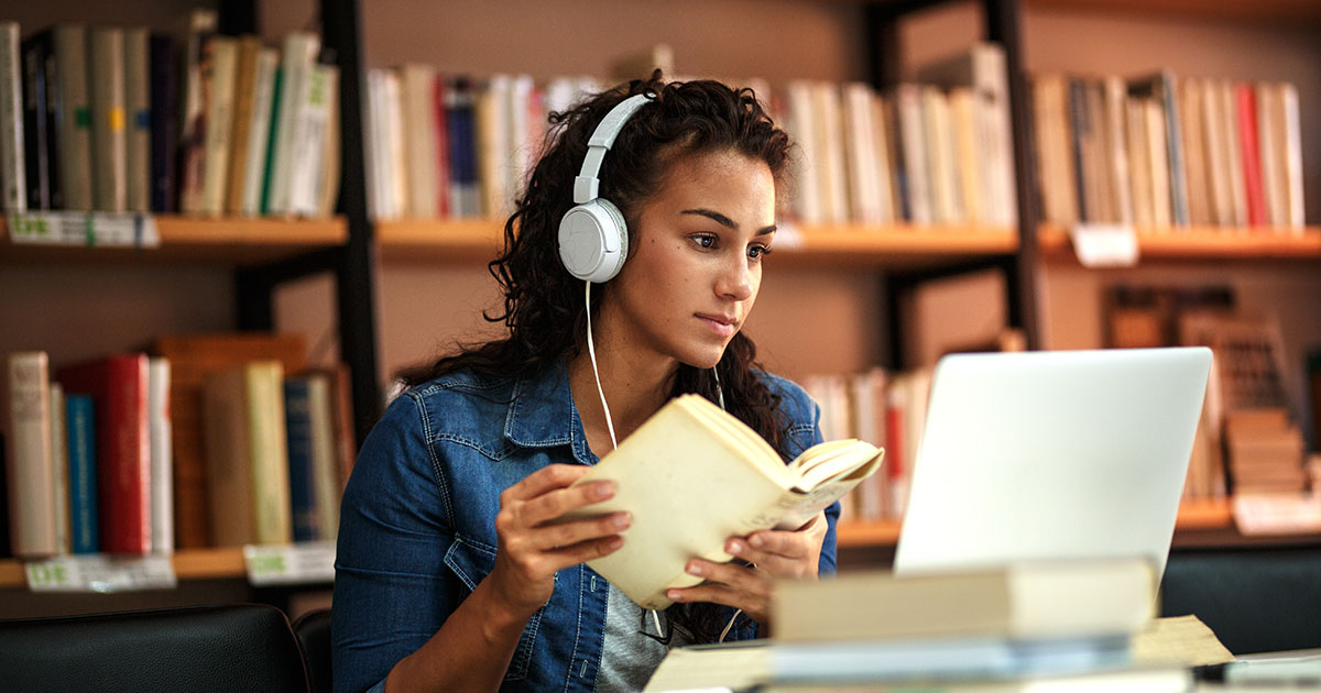 a femail is studying in a library