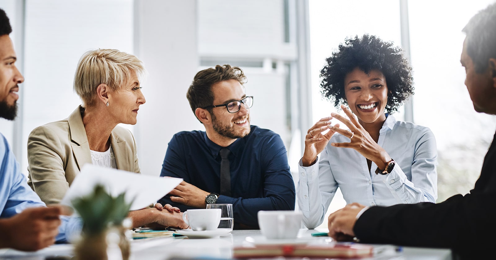 Diverse team members in office collaborate in a meeting