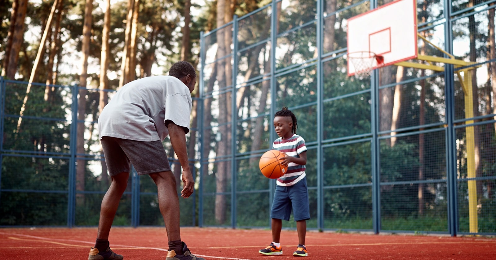 Father with young son on basketball court