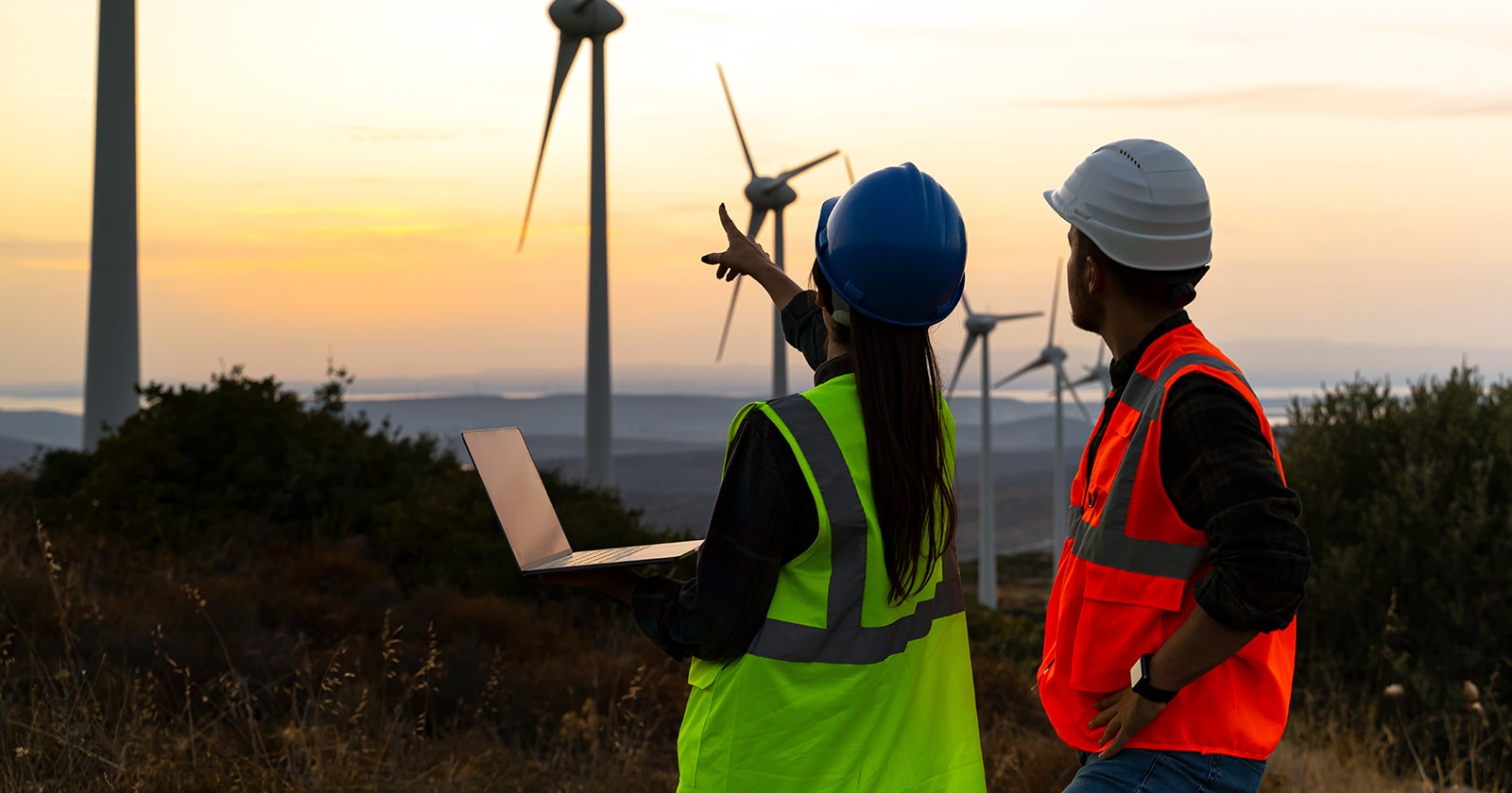 Two utility workers on a wind farm
