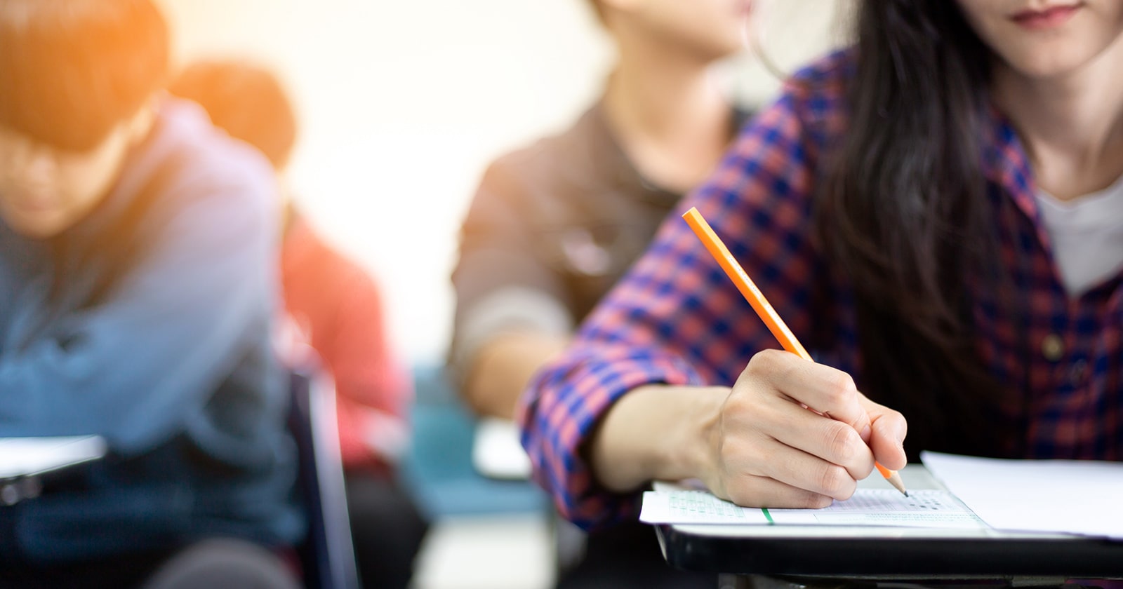 Cropped view of high school girl taking a test in class