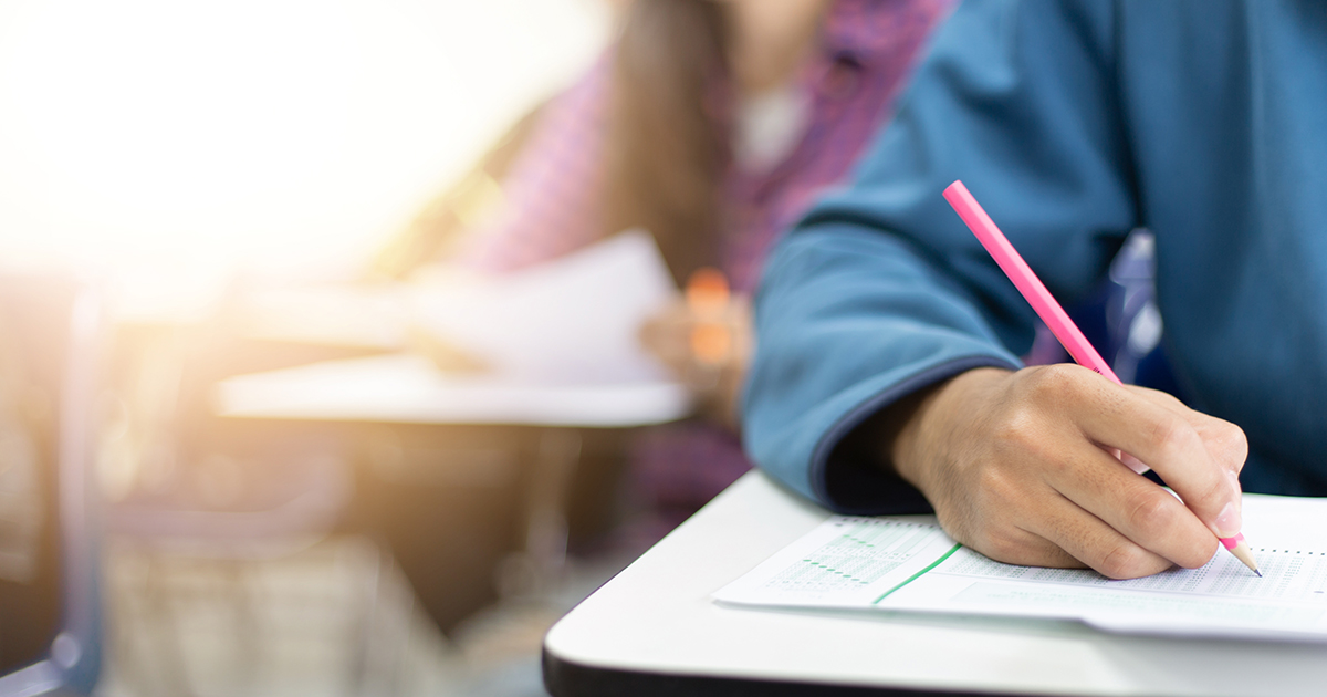 students writing a test in college