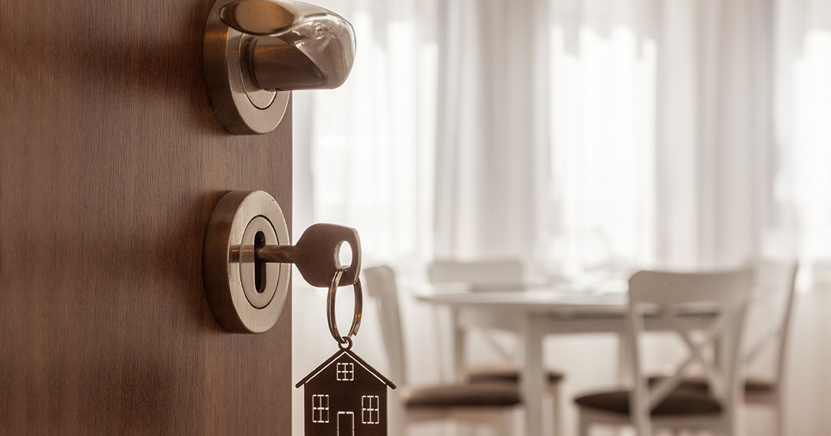 open door with a key in locker to a house