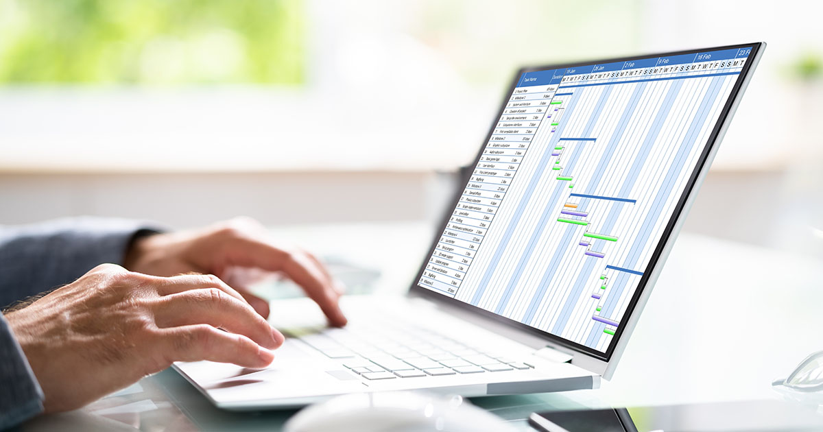 man hands on a laptop with the graph on a screen