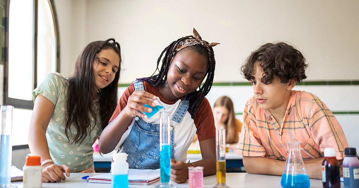 high school students doing an experiment during science class