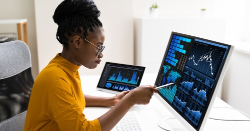Black woman examines data on a computer screen