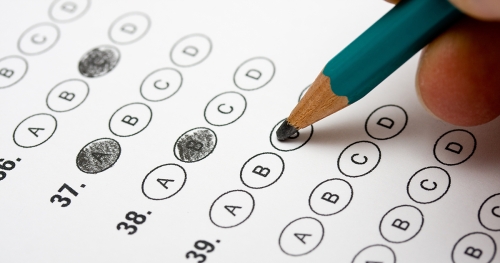 Person filling out a multiple-choice test in pencil