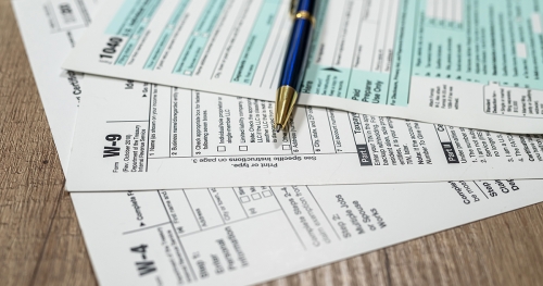 Tax forms spread out on a desk