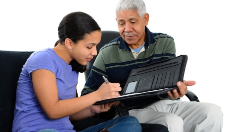Interviewer guiding young woman through set of questions on a tablet