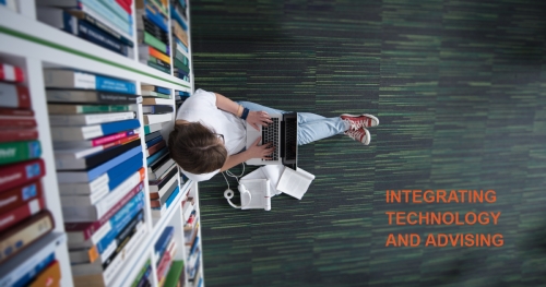 Overhead view of student working on a laptop on the floor of a library