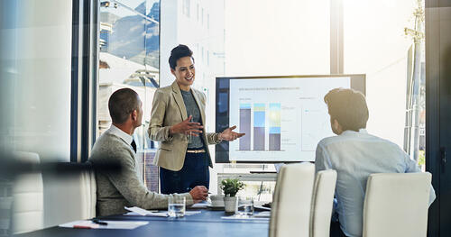 Woman presents data to a small team