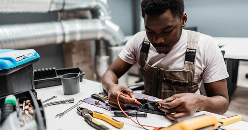 Young technician at work on electronics