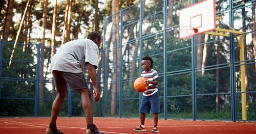 Father with young son on basketball court