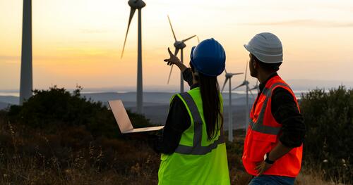 Two utility workers on a wind farm