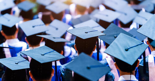 students with graduation hats
