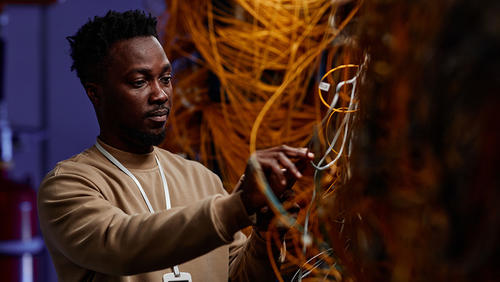 a man in front of many wires