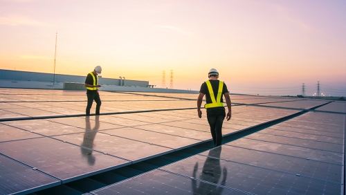 Men working on solar panels