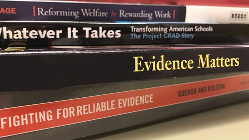 Close-up of books about Evidence, Education, and Welfare