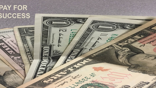 Close-up of US dollars with words 'Pay for Success' overlaid on it