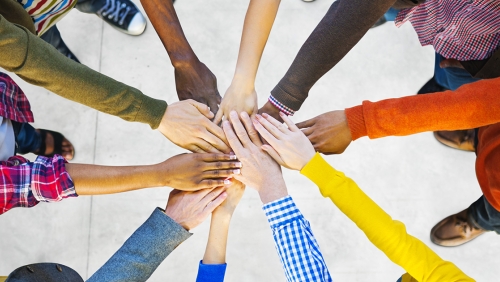 Team of diverse hands in a huddle