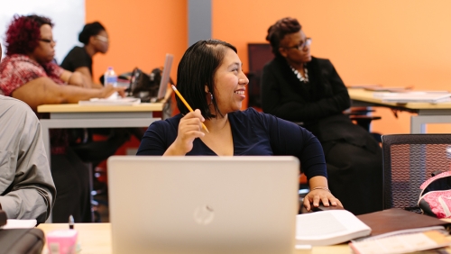 Smiling woman in a computer education class
