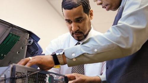 Two men working on a computer