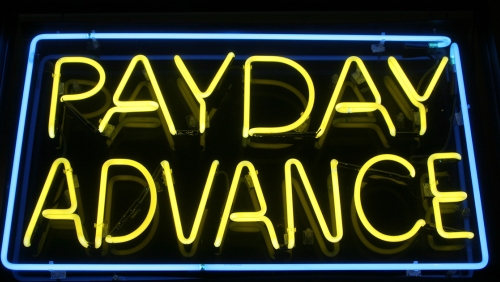 Neon sign reading "Payday Advance"
