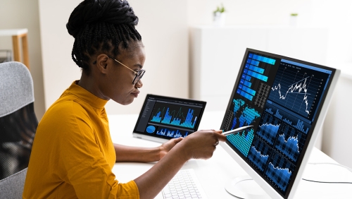 Black woman examines data on a computer screen