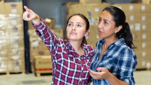 Two women employees in a warehouse