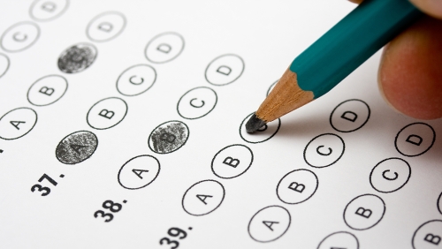 Person filling out a multiple-choice test in pencil