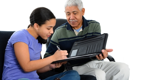 Interviewer guiding young woman through set of questions on a tablet