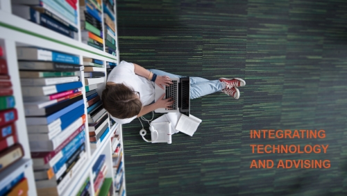 Overhead view of student working on a laptop on the floor of a library