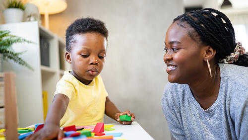 a mother is playing with a baby