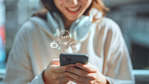 a teenager is texting on a phone