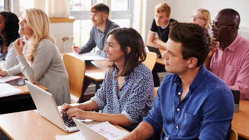 students in a class leasening a professor