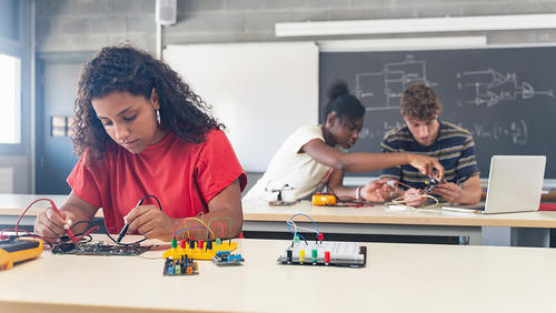 High school students working on circuit boards