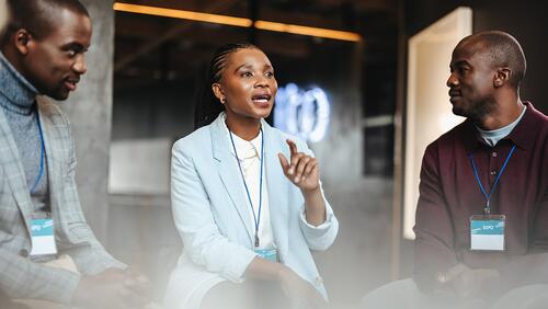 Group of Black businesspeople speaking at a conference