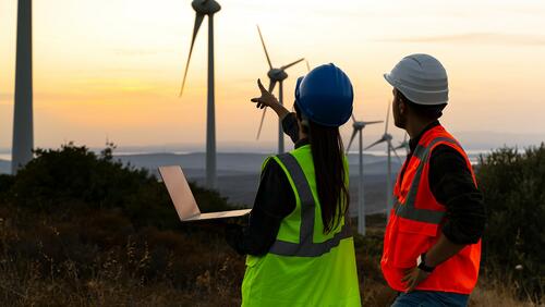 Two utility workers on a wind farm