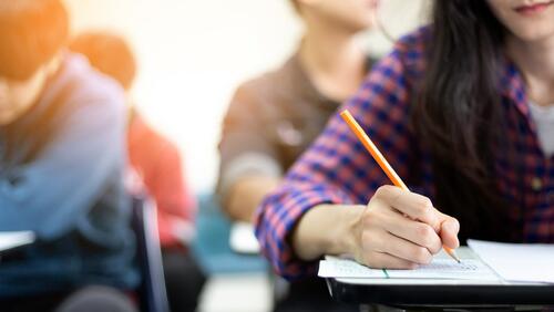 Cropped view of high school girl taking a test in class