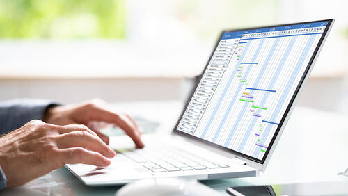 man hands on a laptop with the graph on a screen