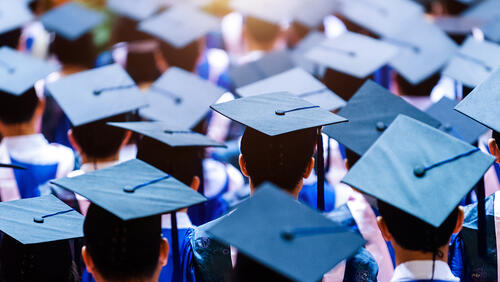 students with graduation hats