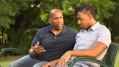 an older mentor is talking to a young guy