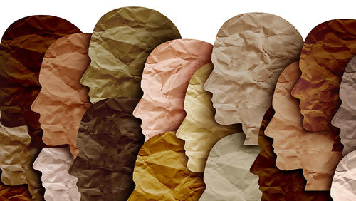 Overlapping paper silhouettes of heads in different shades of brown and pink