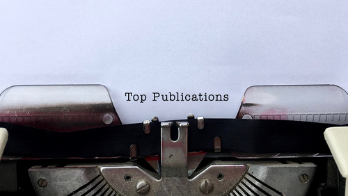 Paper in typewriter that reads Top Publications
