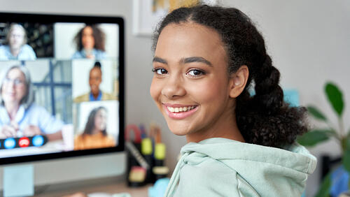 a girl is participating in online tutoring lesson